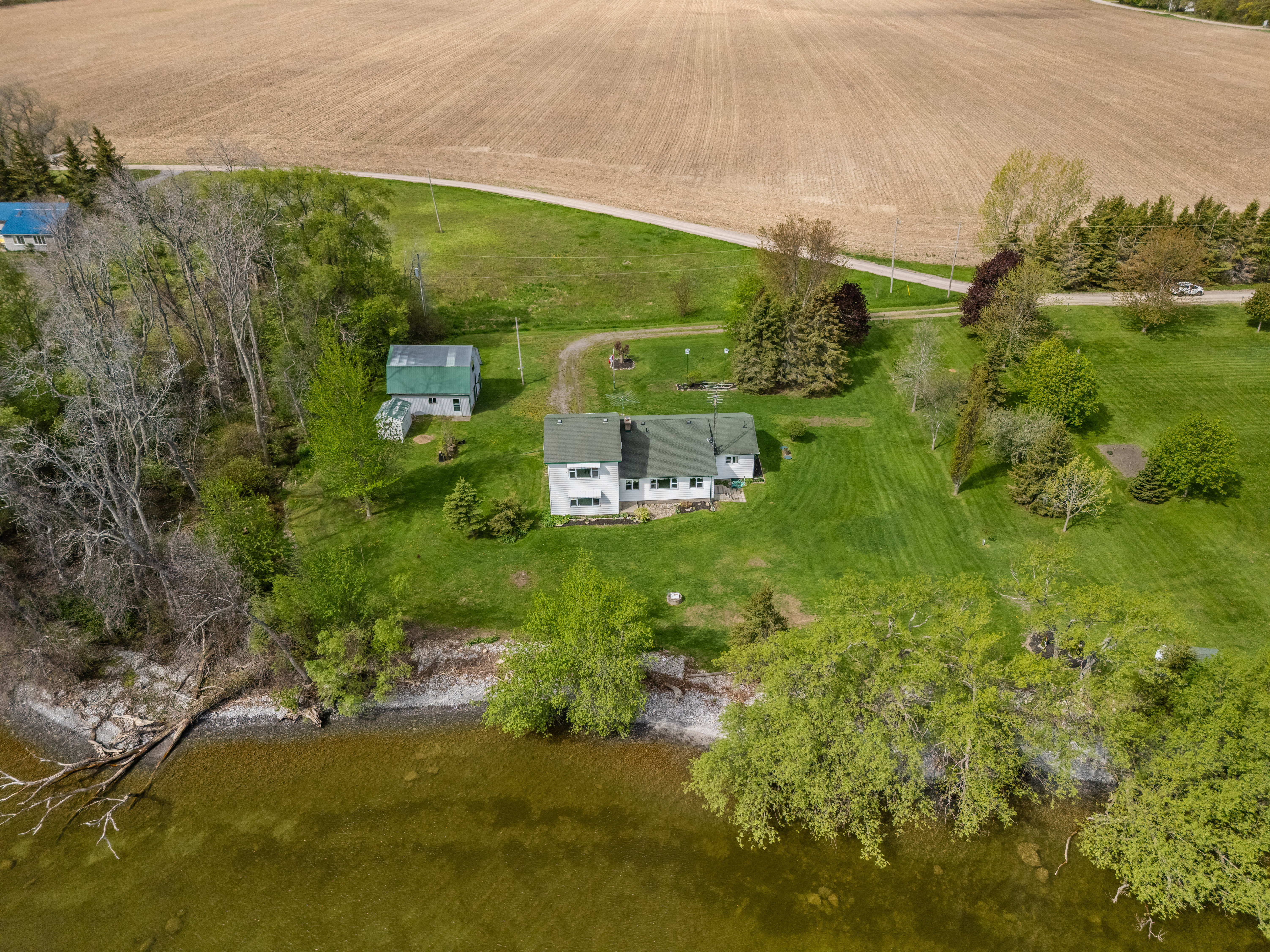 The property along its shoreline with farm fields beyond